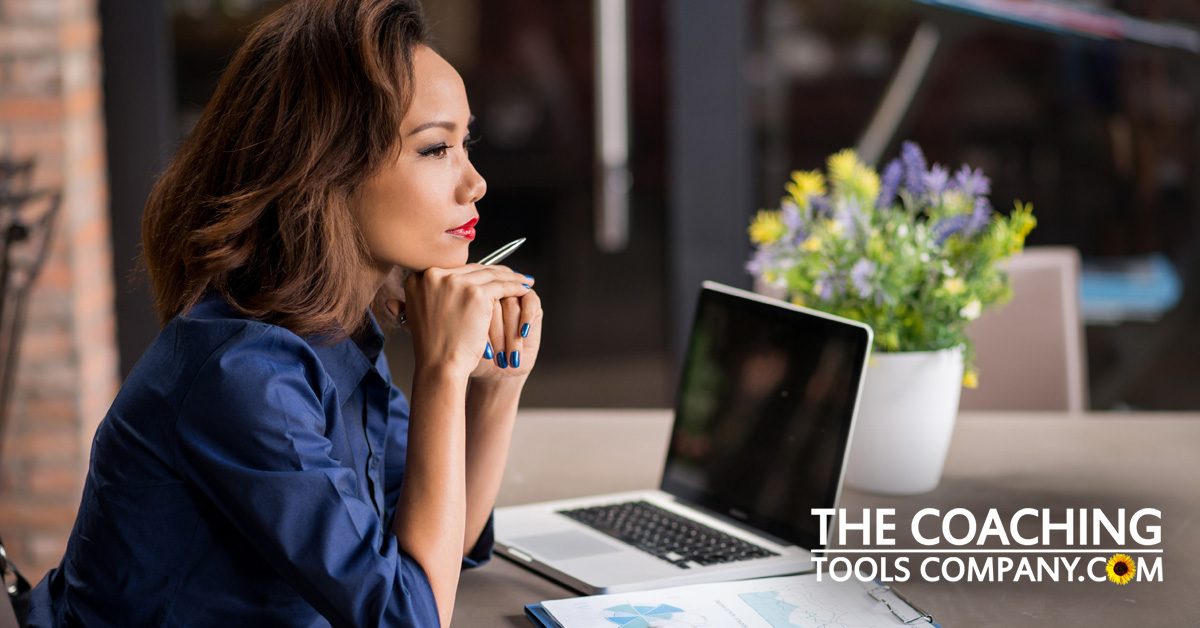 Client (or Coach!) pondering new career ideas at desk with laptop