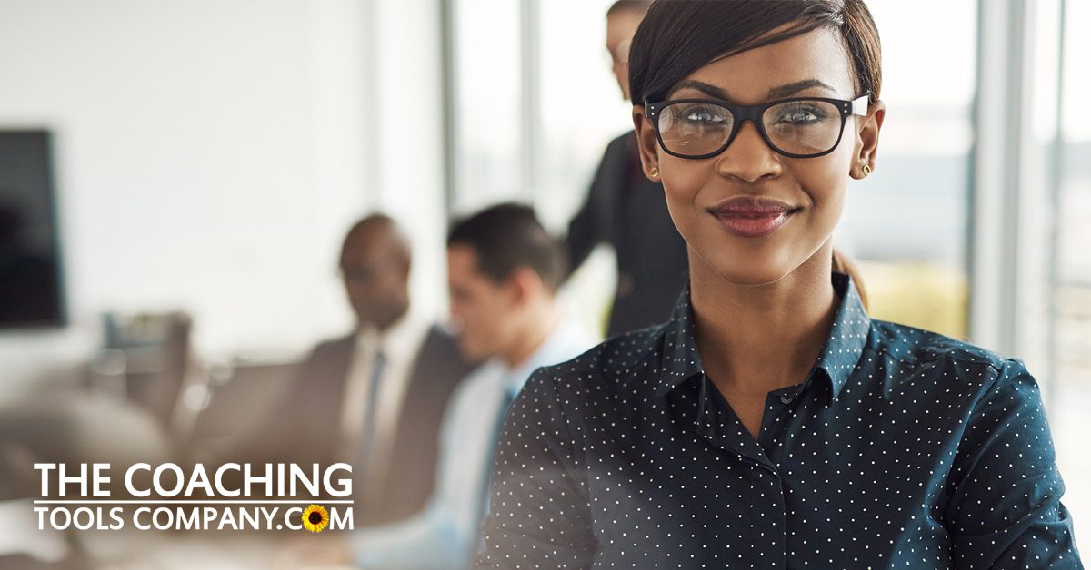 Happy Woman in Office with Colleagues for New Career Coaching