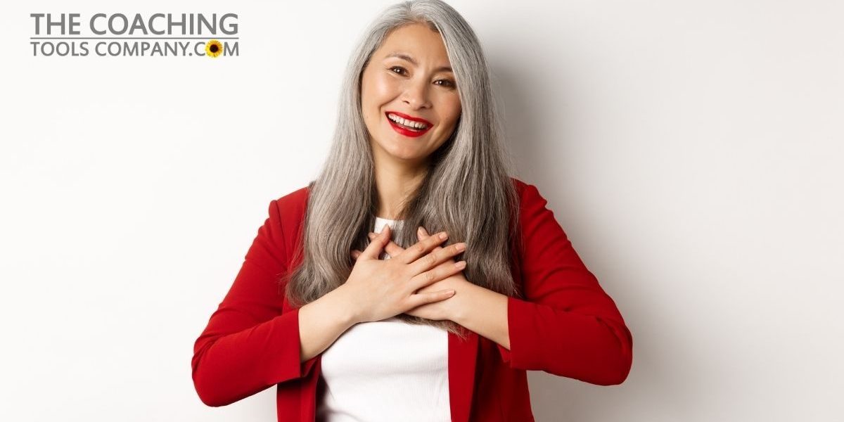 business-concept-mature-asian-woman-with-red-lips-blazer-holding-hands-heart-smiling-thankful-looking-grateful-camera-standing-white-background-1200-x-x628.jpg