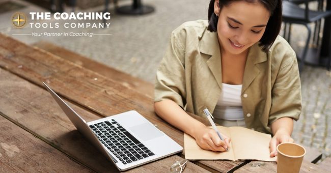 portrait-young-woman-studying-online-sitting-with-laptop-writing-down-making-notes-looking-1200×628-1.jpg