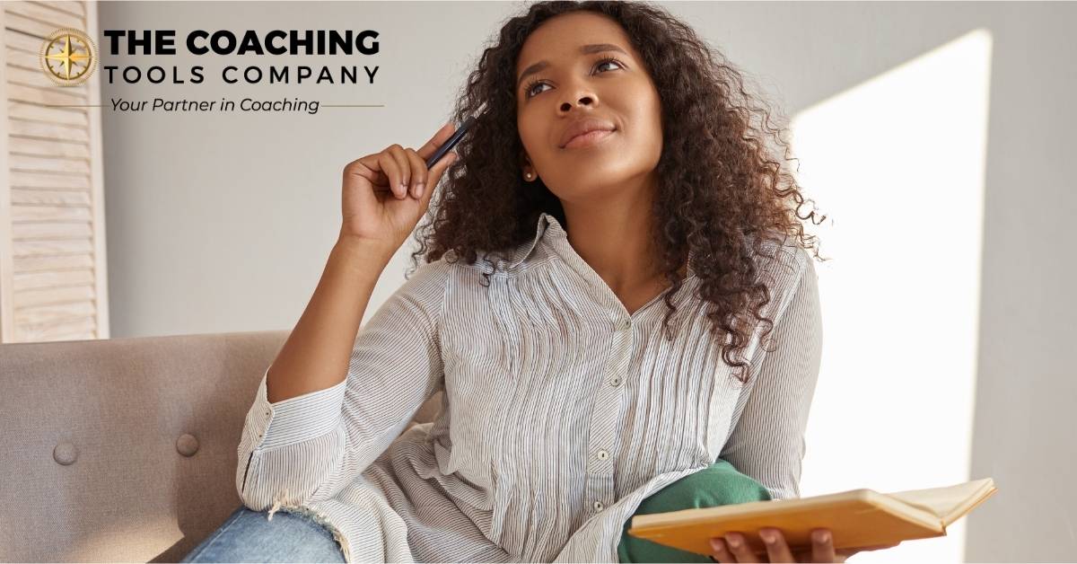 Coach reflecting with a journal as part of a self-care practice